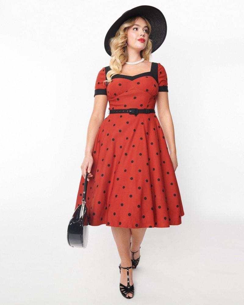 Front of a model wearing a size L Unique Vintage Rust & Black Polka Dot Swing Dress in Red, Black Polka Dots by Unique Vintage. | dia_product_style_image_id:306037